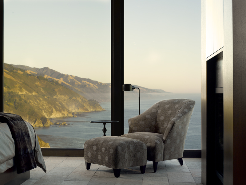 bedroom with ocean view and a chair